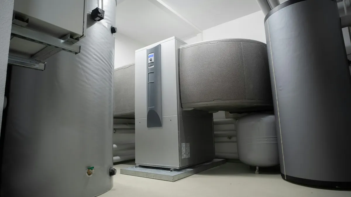 Hot water cylinders and an indoor heat pump unit in a plant room