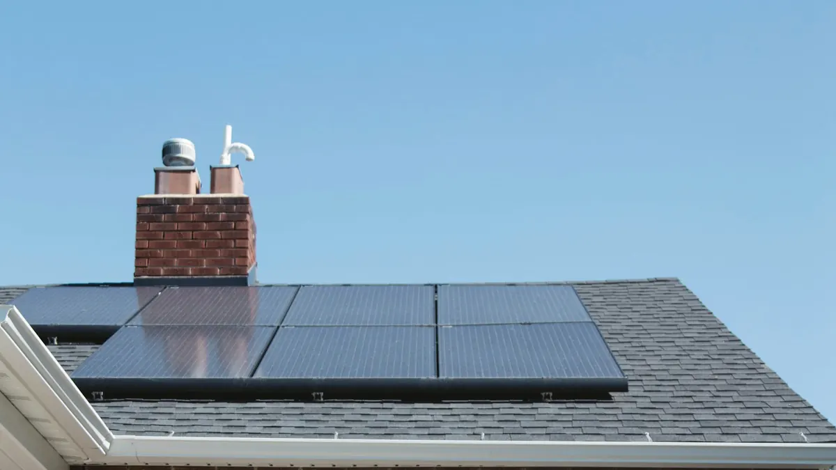 Brick house with solar panels on the roof and chairs outside