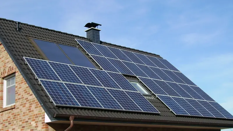 Solar panels on the tiled roof of a brick house